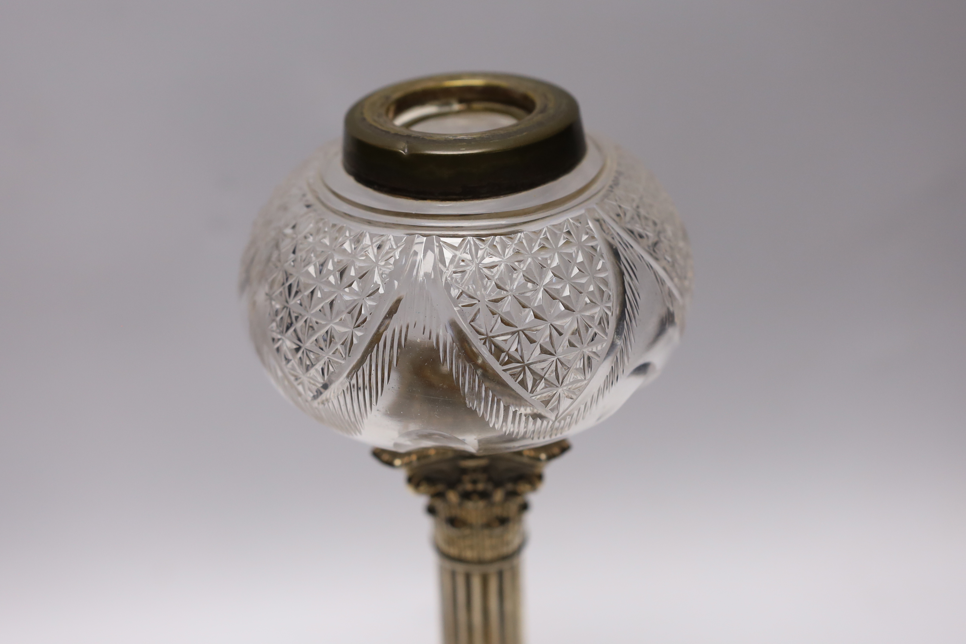 An Edwardian silver mounted Corinthian column candlestick, Thomas Bradbury & Son, London, 1901, 23cm, now with a silver plate mounted glass reservoir.